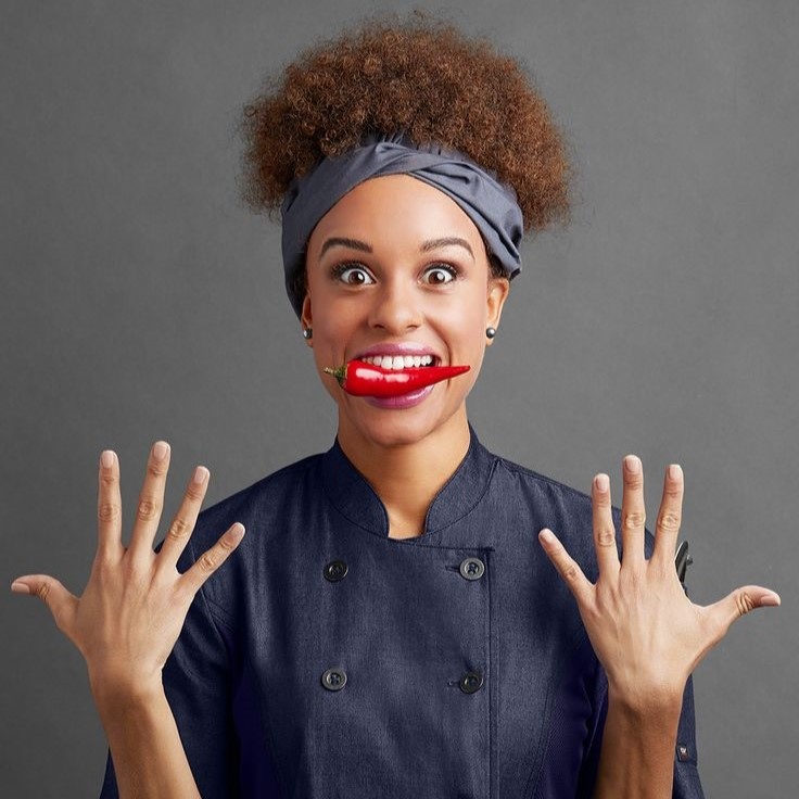 female chef with pepper in her mouth